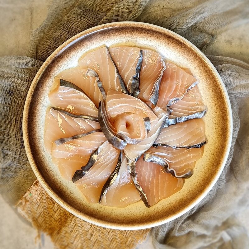 Sliced marinated batang fish arranged on a plate